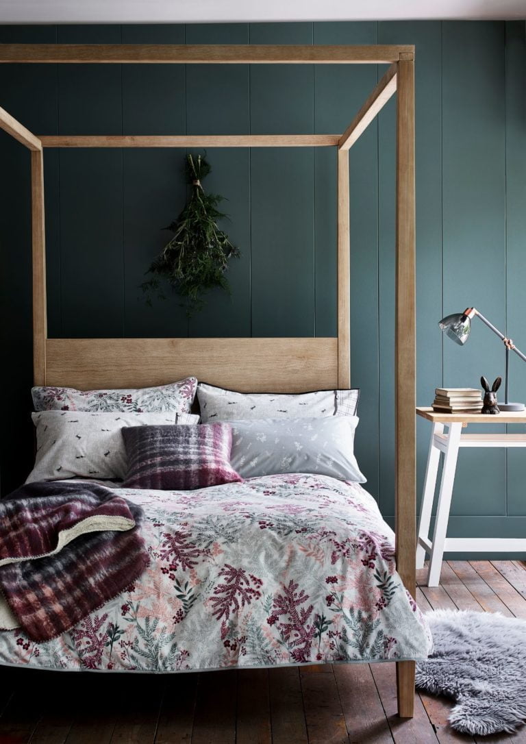 Teal painted room with Argos Highland Four-Poster Bed styled with a Brushed Check Cushion and blankets