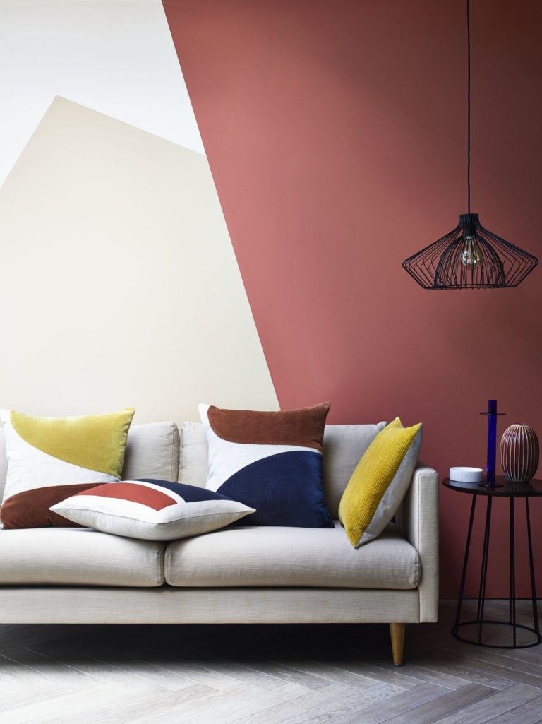 Modern sofa with vibrant cushions and side table