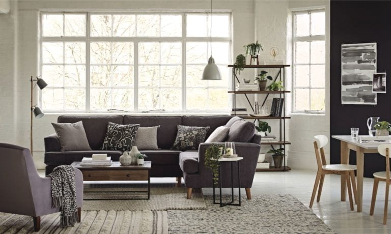 Grey corner sofa with selection of soft rugs from Marks and Spencer