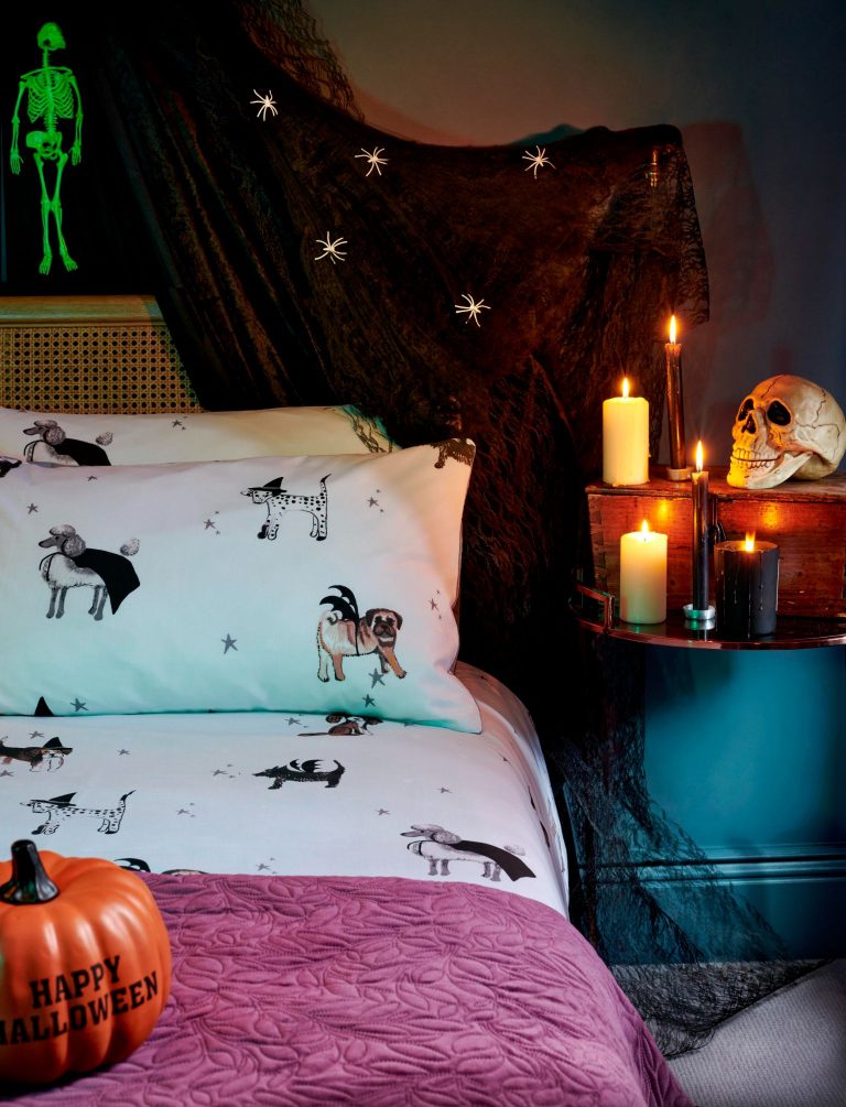 White bedding illustrated with different dog breeds wearing batwings for Halloween 2020. Cute Halloween bedding from Asda.