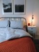 Soft coverless duvet with orange blanket and warm vintage-style LED lights