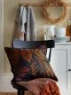 Black cushion with orange autumn leaf print