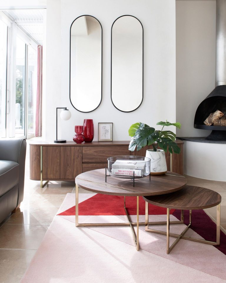 Dark brown round next coffee tables, set of two with gold metal legs. Large dark brown TV media unit with gold metal accents.