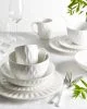 White dinner set with triangular indents along the edge of the plates.