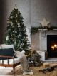 Christmas tree beside fireplace