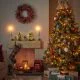 Traditional colourful Christmas tree next to a fireplace