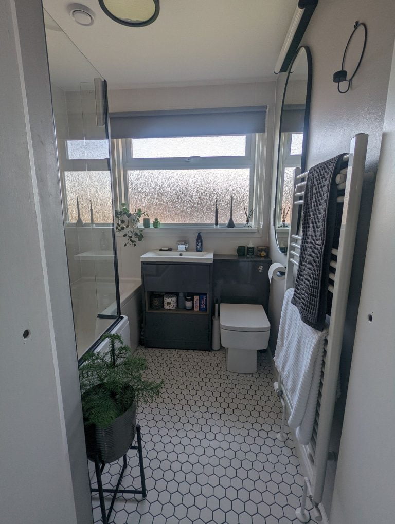 1970s family bathroom renovation with hexagon flooring and white tiles.
