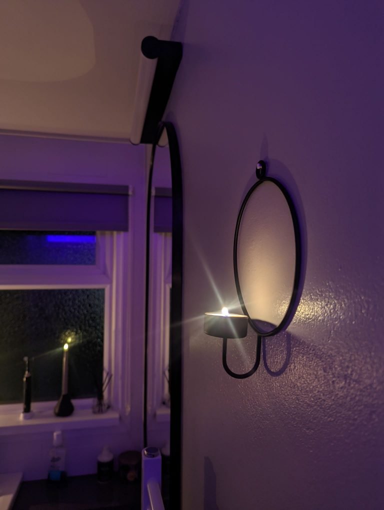 Round black tealight wall holder.