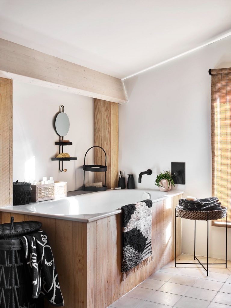 Modern bathroom with wood accents and black fixtures and fittings.