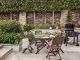 Dark acacia wood round dining table with chairs that can be folded away for easy storage.