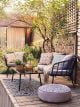 Black rattan outdoor two seater sofa, armchairs and glass coffee table.