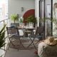 Grey metal outdoor dinning table and chairs that can be folded away.