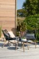 Relaxed black woven rope chairs with light wooden legs.