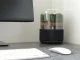 Stylish black and glass air purifier on a desk.