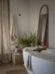 Free-standing oval bath, decorative border marl towels and white marble tray from John Lewis.