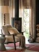 Gondola Club Chair from John Lewis draped in a neutral blanket, soft cushion and in front of a corner fireplace.