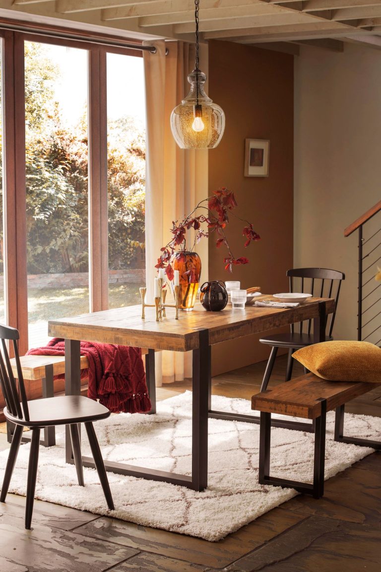 Thick wooden pine 4 seater bench dining set from Next, surrounded by autumn colours and decorations.
