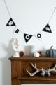 Black and white felt halloween bunting with ghosts and the word 'boo'.