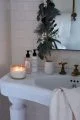 Bathroom at Christmas with a candle, egyptian cotton scented hand wash and green garland.