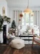 Bright white lounge with Christmas presents, boho lampshades and boho Christmas decorations hanging from the window.