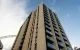 Large towering apartment block with the famous arch of Wembley Stadium in the background.