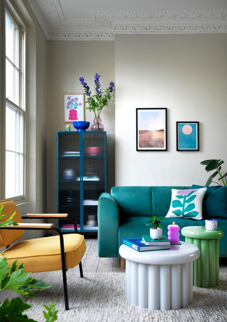 Turquoise sofa, blue cabinet with reeded glass and bright coffee tables.