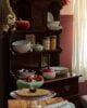 Wooden sideboard with autumn decorative bowls, plates and accessories.