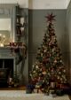 Green Victorian lounge with a large Christmas tree, decorated with a traditional style of red baubles and gold by Habitat.