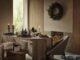 Neutral Christmas dinner table with a fabric table cloth, wooden trees and candles from Marks and Spencer.