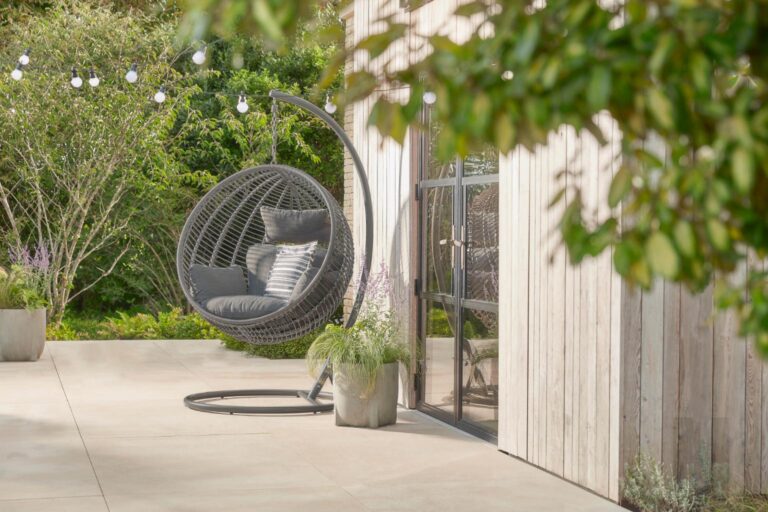 Industrial style round hanging egg chair with wicker, by Cox & Cox.