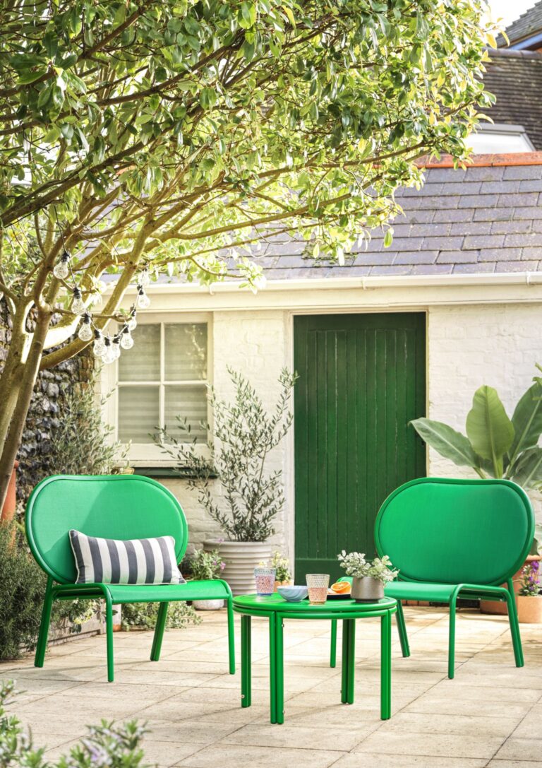 Bold green curvy garden armchairs by Habitat.
