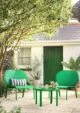 Bold green curvy garden armchairs by Habitat.