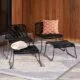 Modern black garden lounge chairs made from metal and rope with foot rests by Ruma.