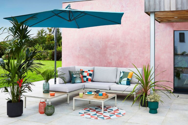 Modern corner sofa with grey cushions, grey metal and wood coffee table by Dunelm.