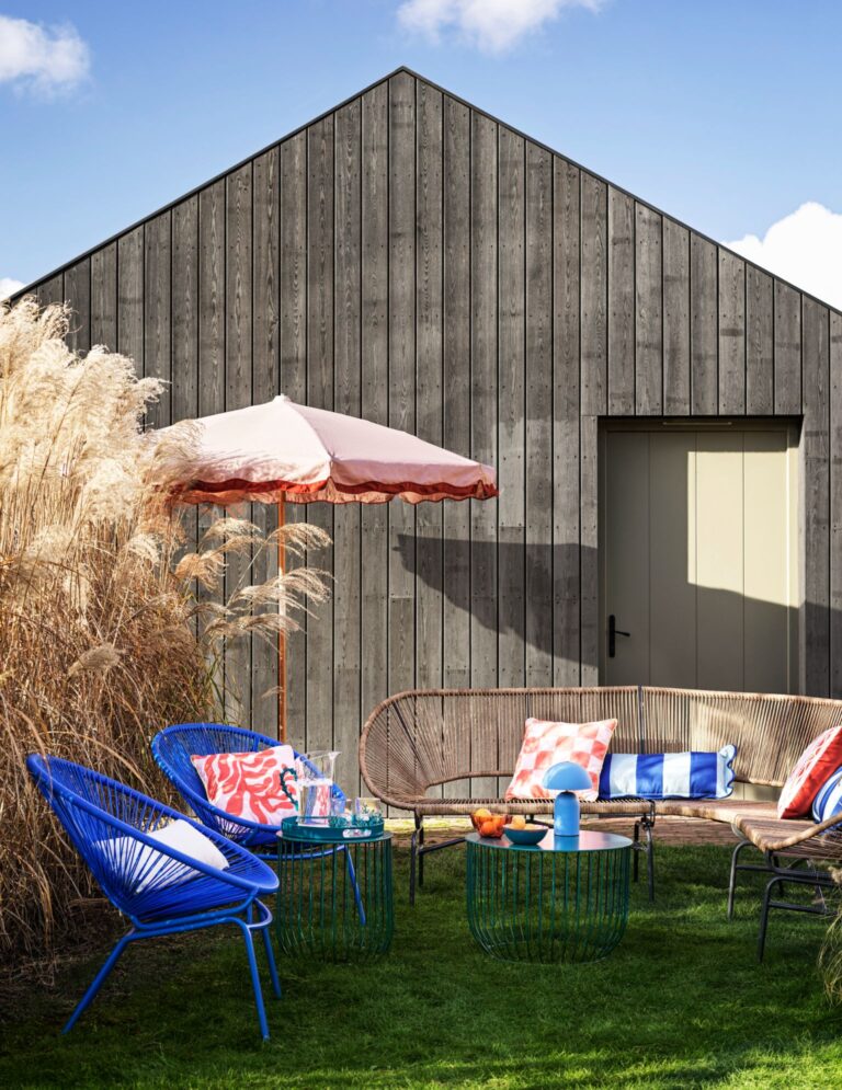 Rattan corner sofa with black legs and modern coffee table by M&S.