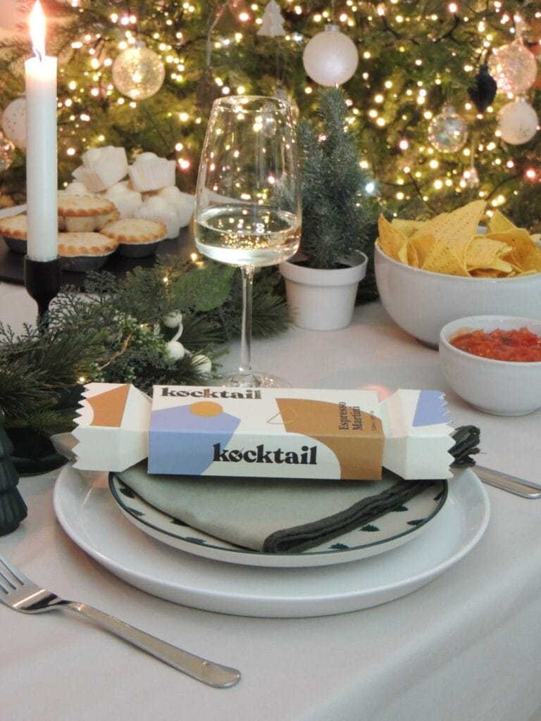 Christmas cracker with cocktail at a dinner place.
