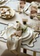 Neutral white Christmas dinner table with embossed white star plates.