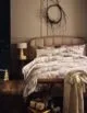 Plain bedroom with brushed cotton winter scene bedding from Marks and Spencer.