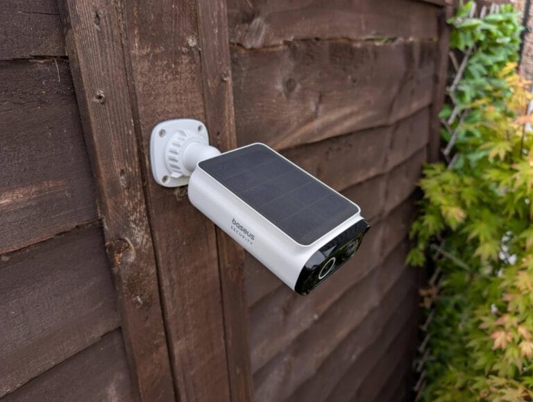 Baseus S1 Lite Outdoor Camera with built-in solar panel, looking down with it fixed on a fence post.