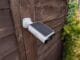 Baseus S1 Lite Outdoor Camera with built-in solar panel, looking down with it fixed on a fence post.